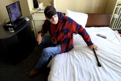 Elderly man sitting in bed.
