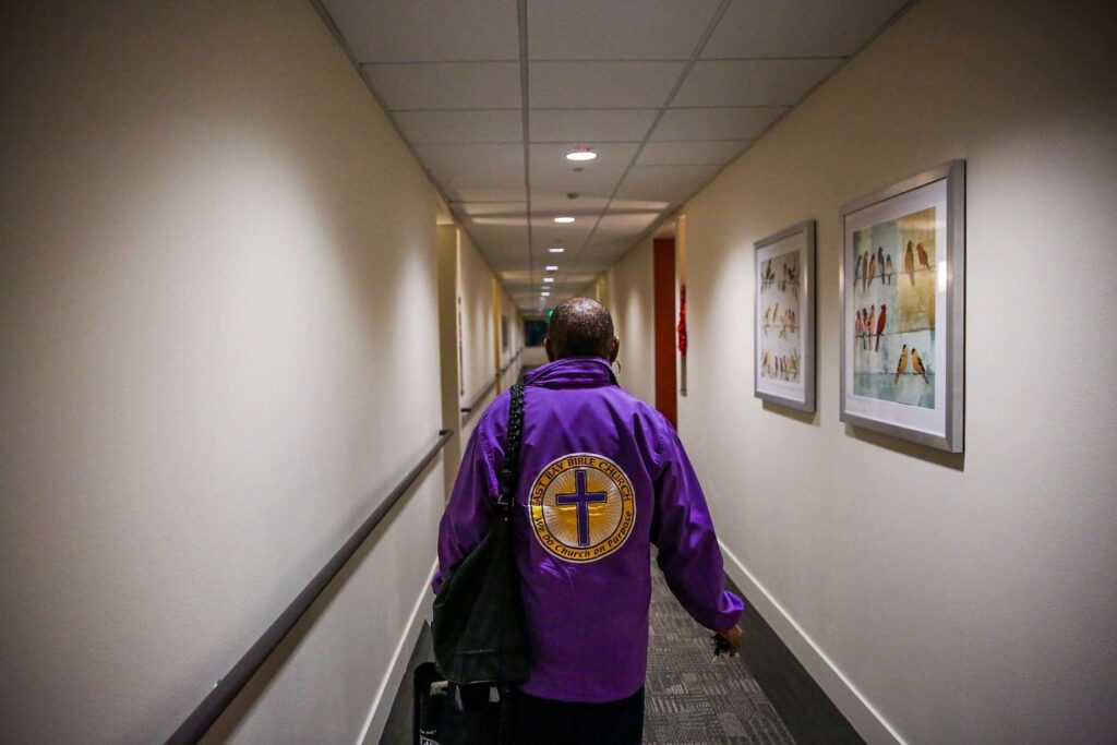 Person walking down a hallway in an apartment building.