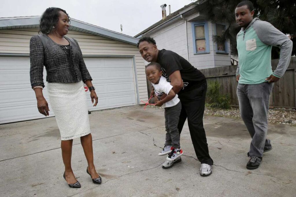 A family plays together on a sidewalk—demonstrating trust and shared joy.