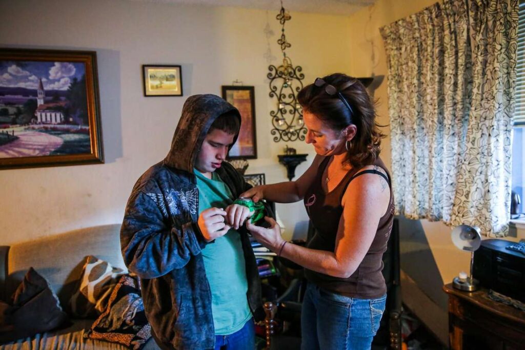 A woman and child in a warmly decorated room sharing a light moment.