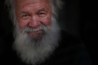 Close up of elderly man with long beard.