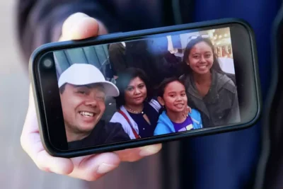Group selfie of three women and a man smiling outdoors.