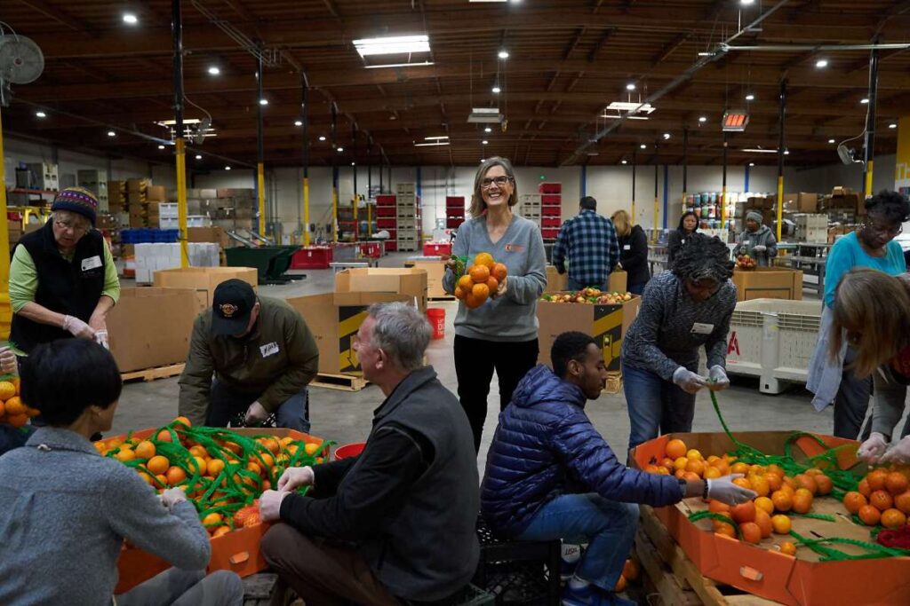 Food bank volunteers sorting through donations and supplies.