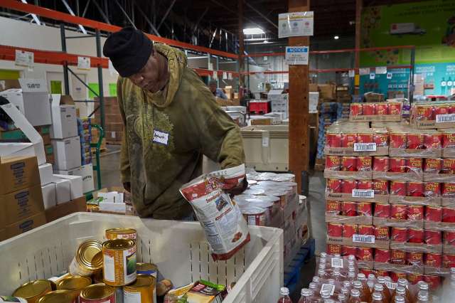 Volunteer sorts through supplies at food bank.