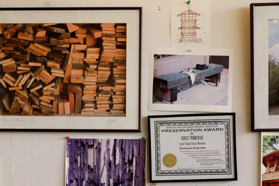 Framed art, photos and accomplishments on a wall.