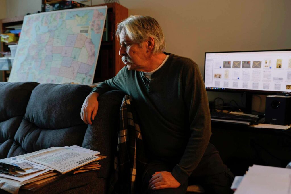 A man sits in office while working on computer—representing learning.