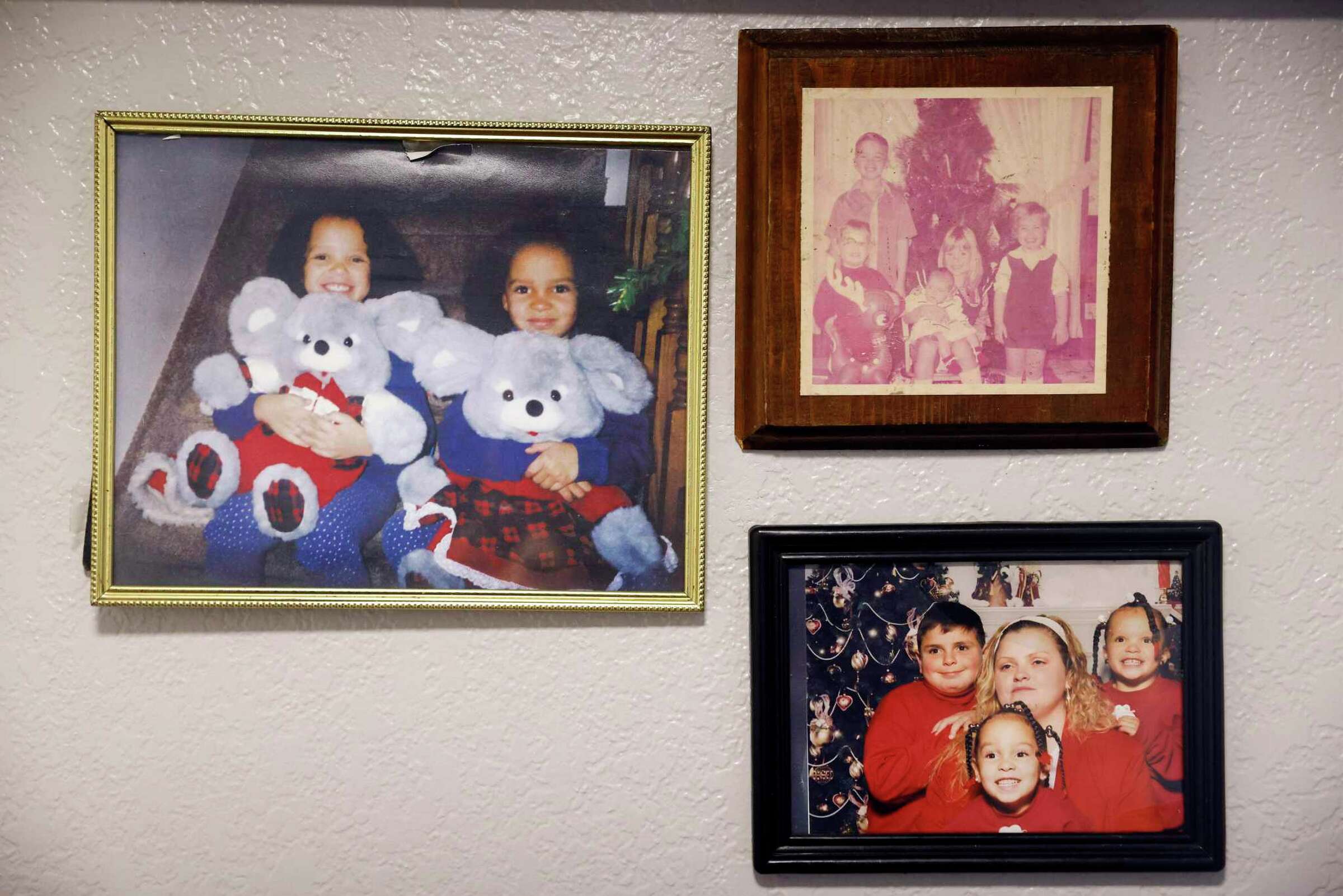 A wall of framed family portraits, including holiday photos—celebrating memory and lineage.