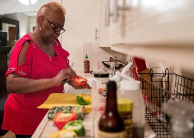 Woman chopping vegetables in a kitchen.