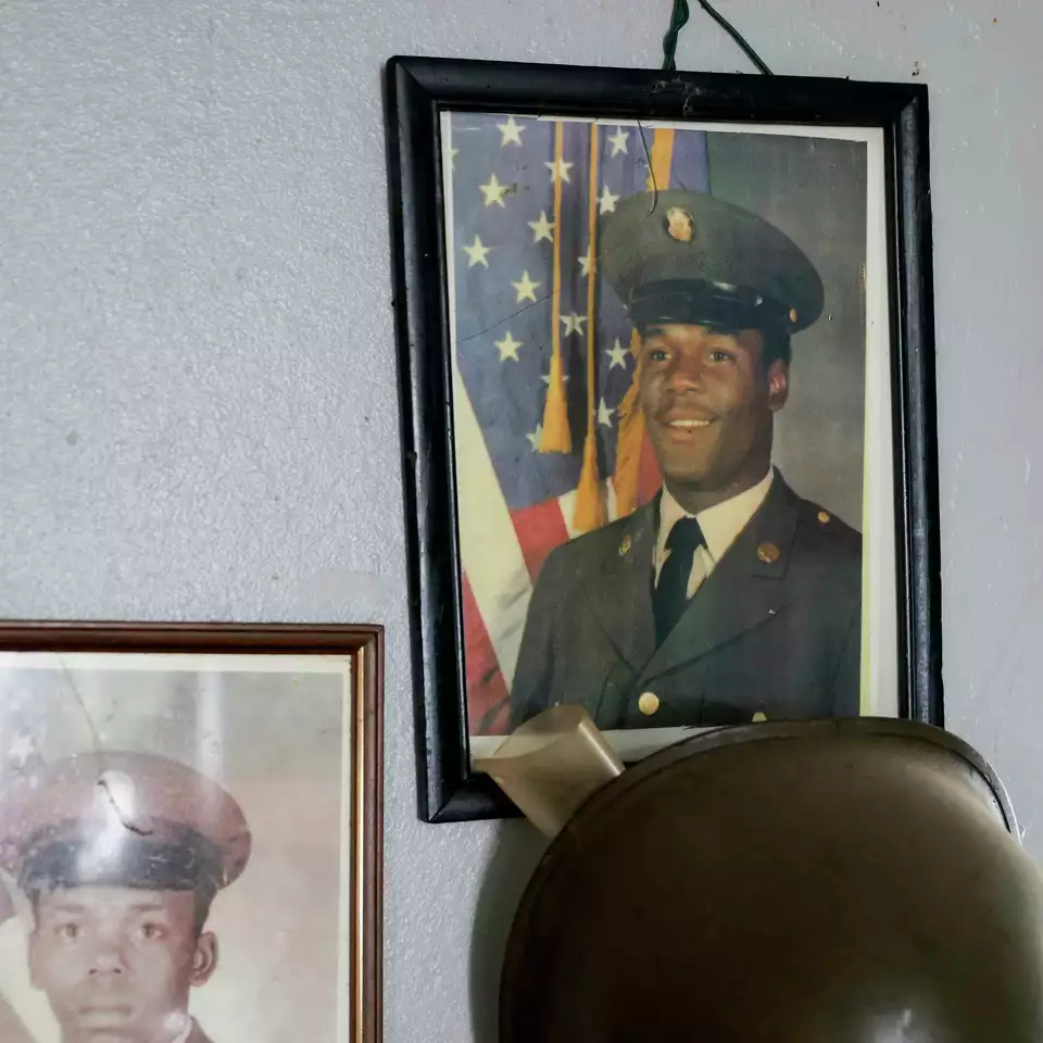 A framed portrait of a military veteran in uniform, surrounded by mementos—honoring service and legacy.
