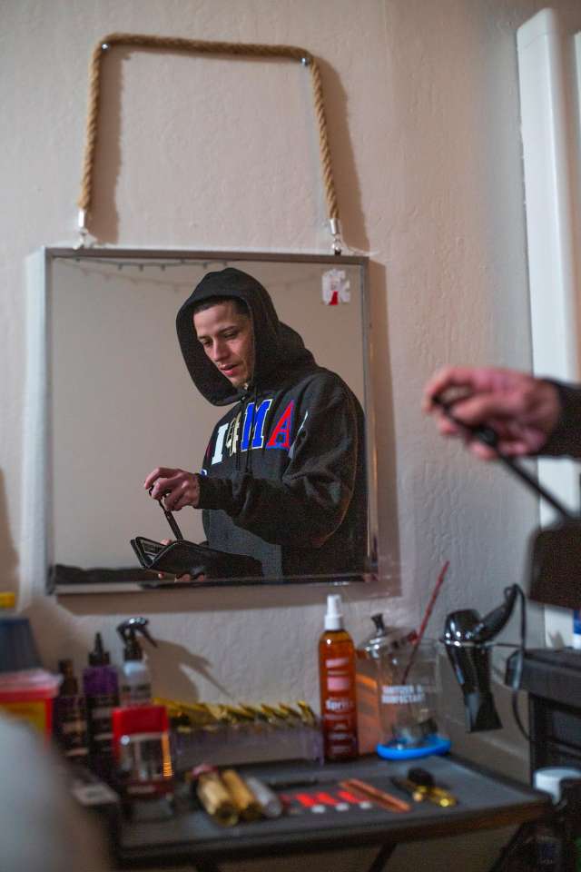 Young man in his home barbershop.