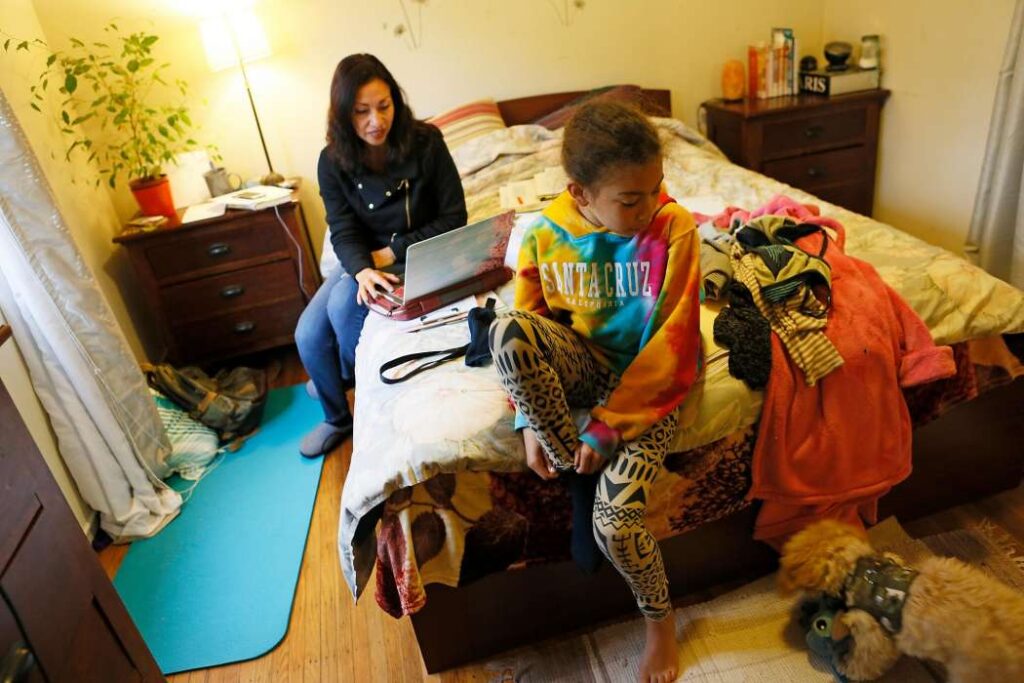 Family gathered on a bed.