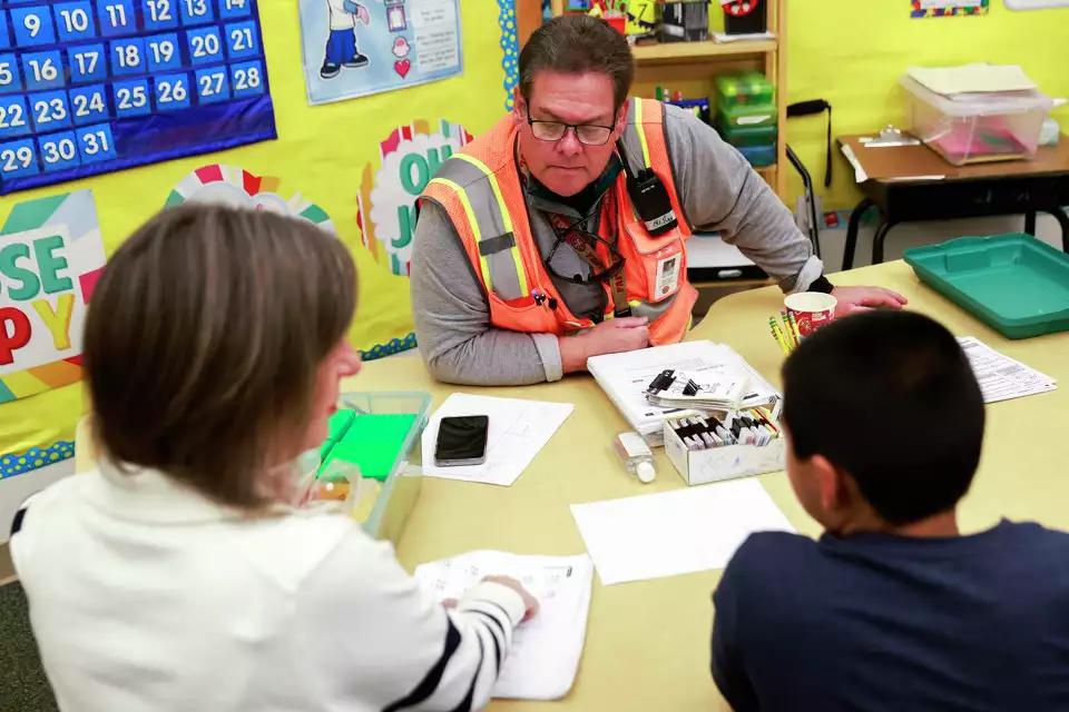 A man and student work together at a desk—emphasizing education and personal attention.