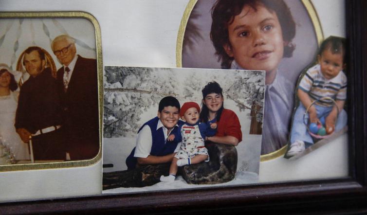 A group of framed family photos shows three smiling individuals—preserving memory and connection.