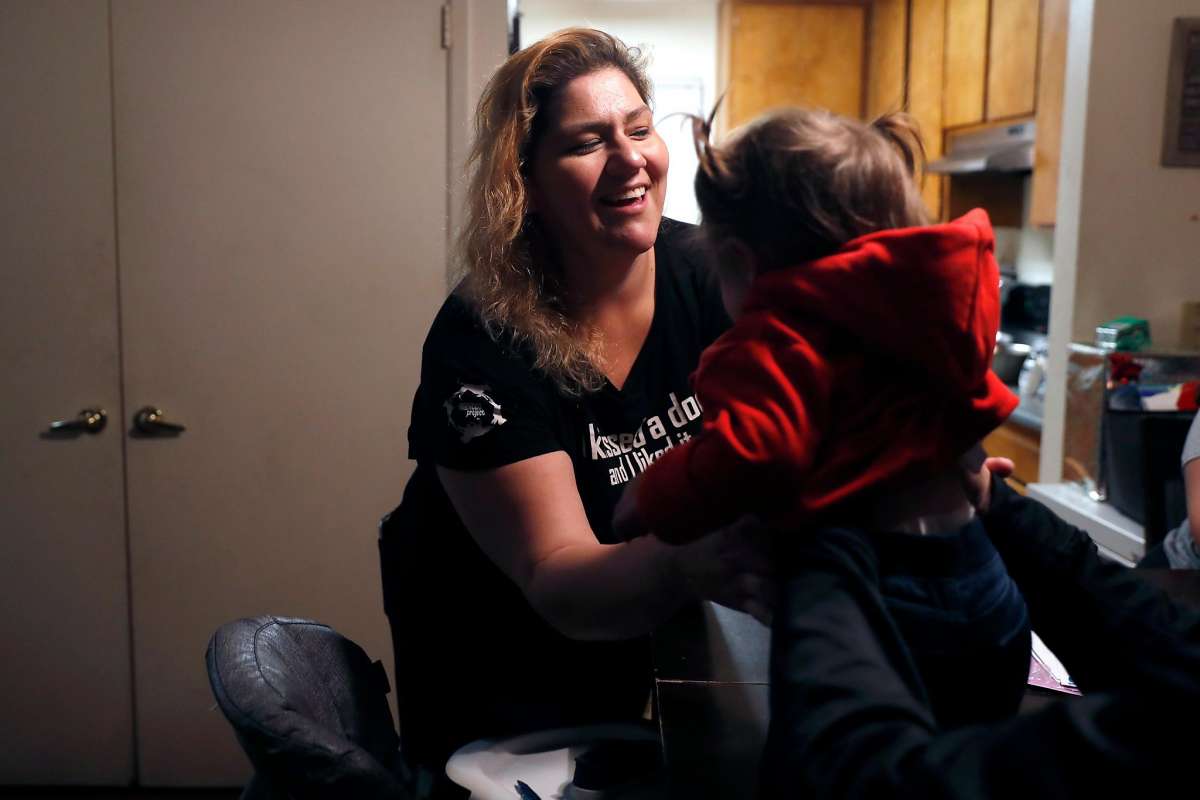 Mother picks up child.