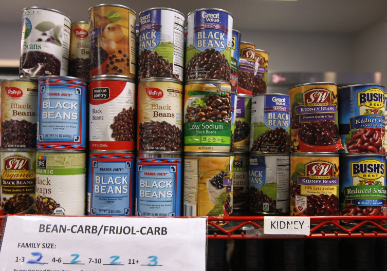Stacked canned goods at food pantry.