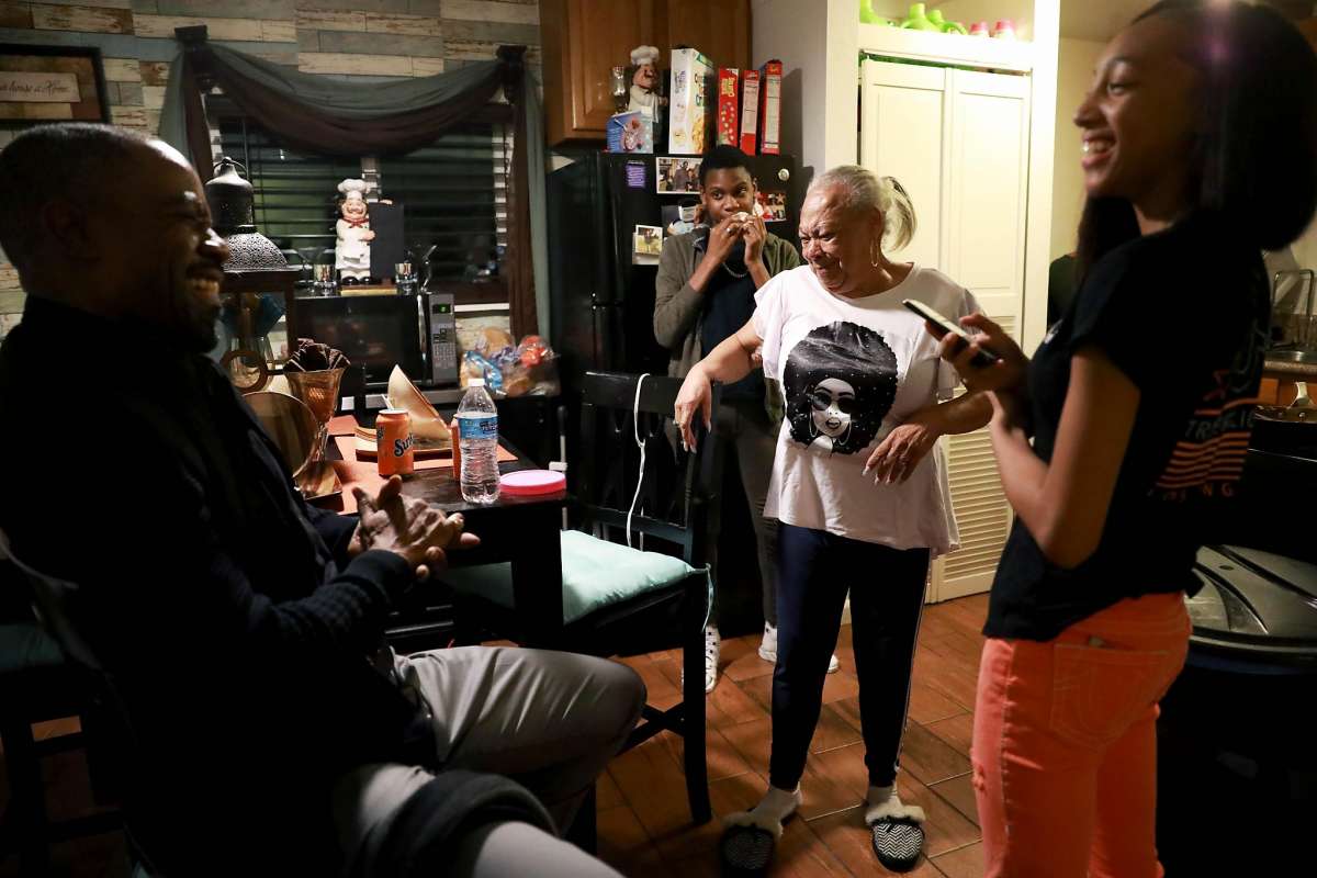 Family enjoys time together in kitchen.