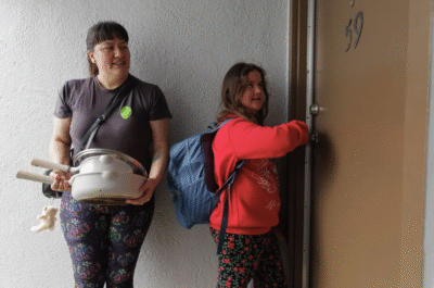 Mother and child knock on a door