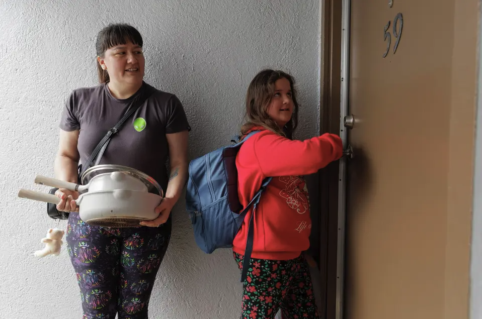 Mother and child knock on a door