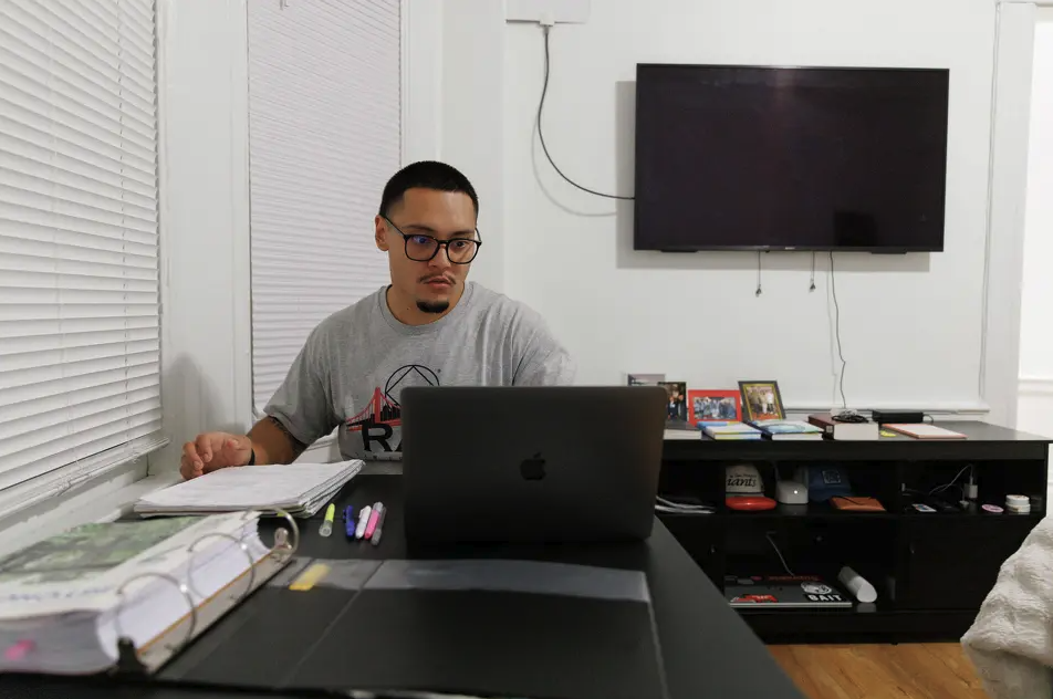 Man at desk with laptop.